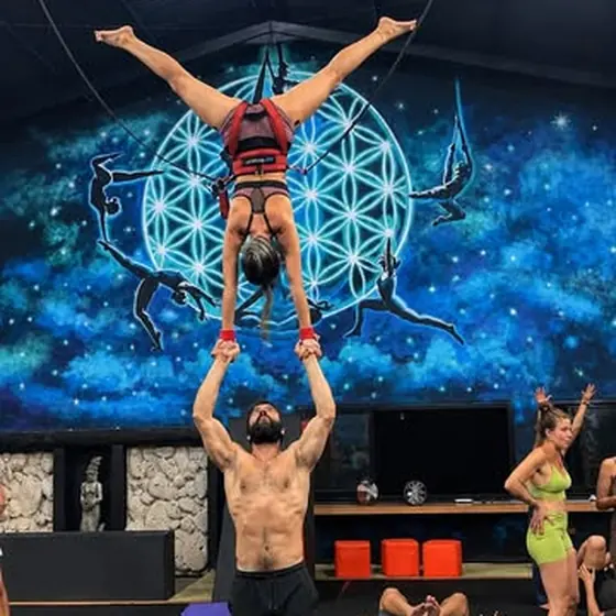 Acro jam at Planet Circus Movement — a flyer held overhead in a hand-to-hand